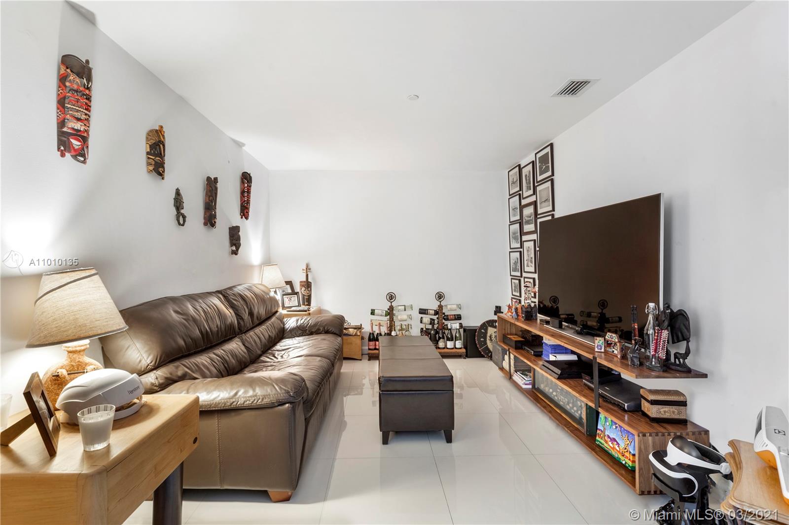 495 Brickell Avenue, Unit 1802 Miami, FL 33131 - Photo 20 of 29 a living room with furniture and a flat screen tv