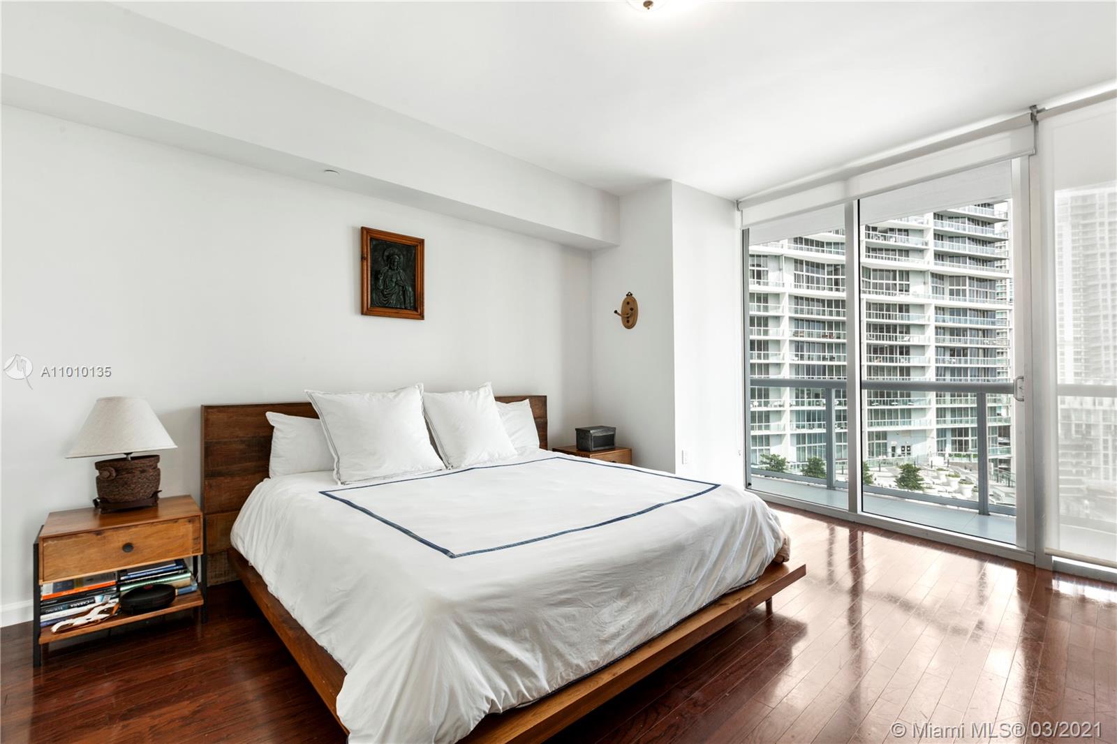 495 Brickell Avenue, Unit 1802 Miami, FL 33131 - Photo 9 of 29 a bedroom with a large bed and a large window