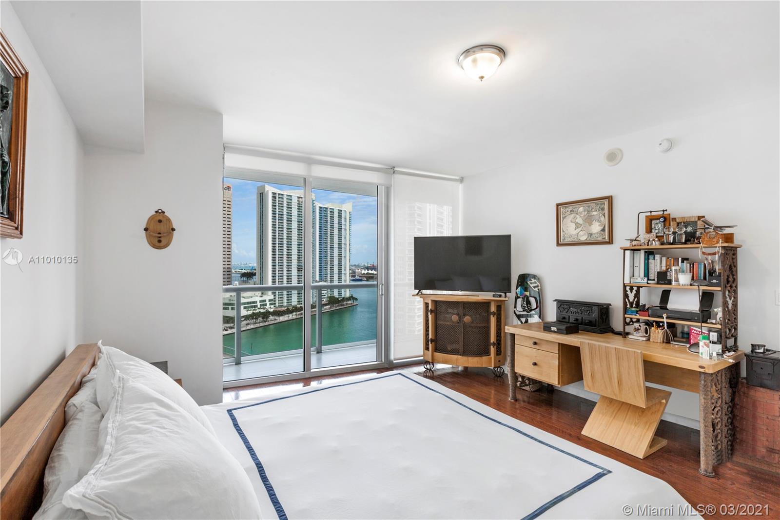 495 Brickell Avenue, Unit 1802 Miami, FL 33131 - Photo 10 of 29 a bedroom with furniture and a flat screen tv
