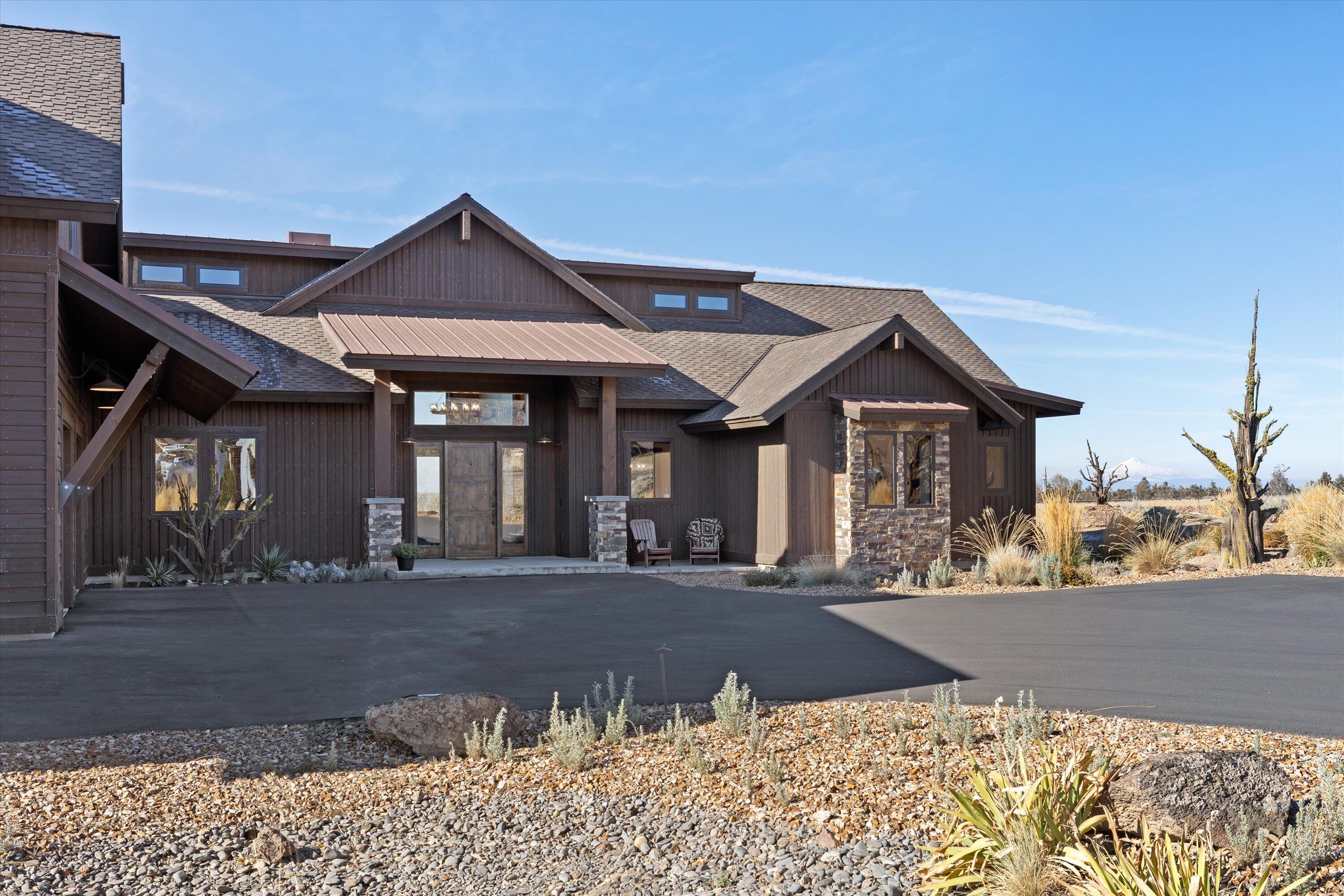 15626 South W Brasada Ranch Road Powell Butte, OR 97753 - Photo 5 of 81 a front view of a house with a yard