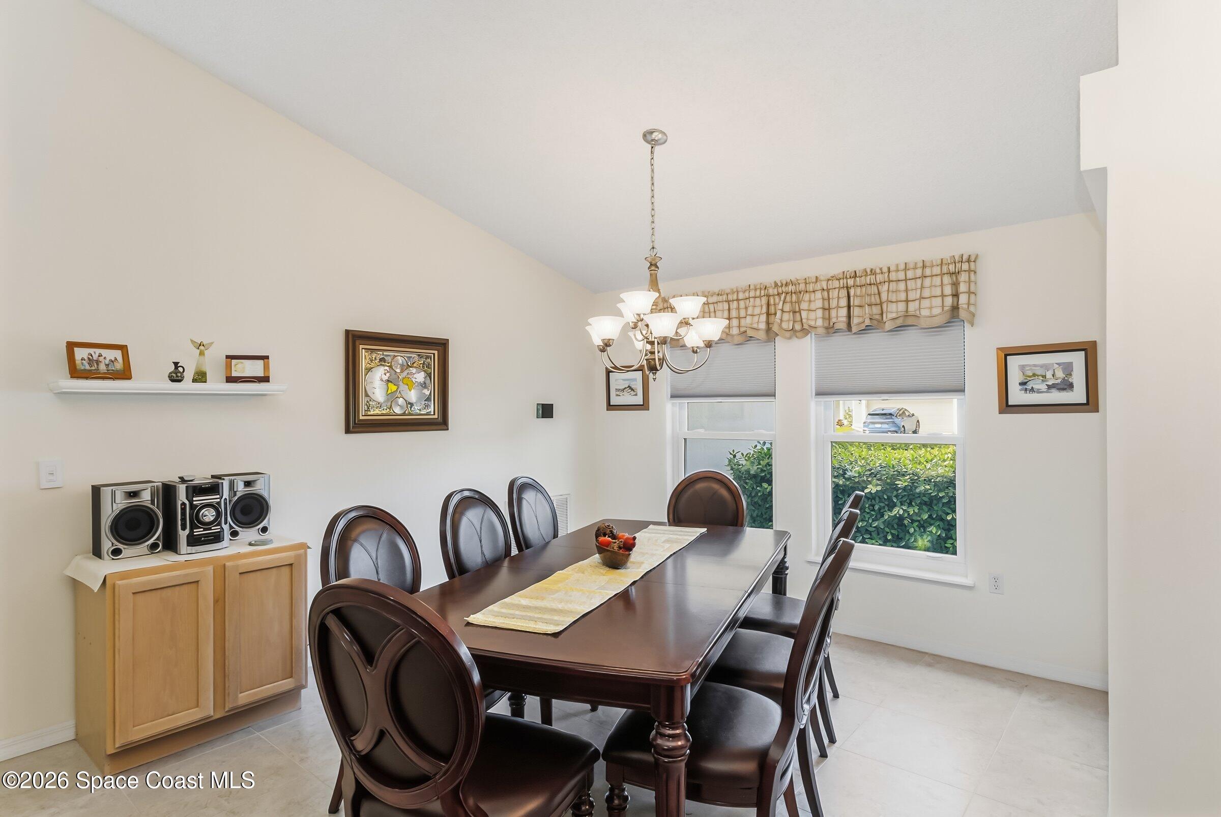 263 Mcclain Drive Melbourne, FL 32904 - Photo 16 of 56 a view of a dining room with furniture a chandelier and window