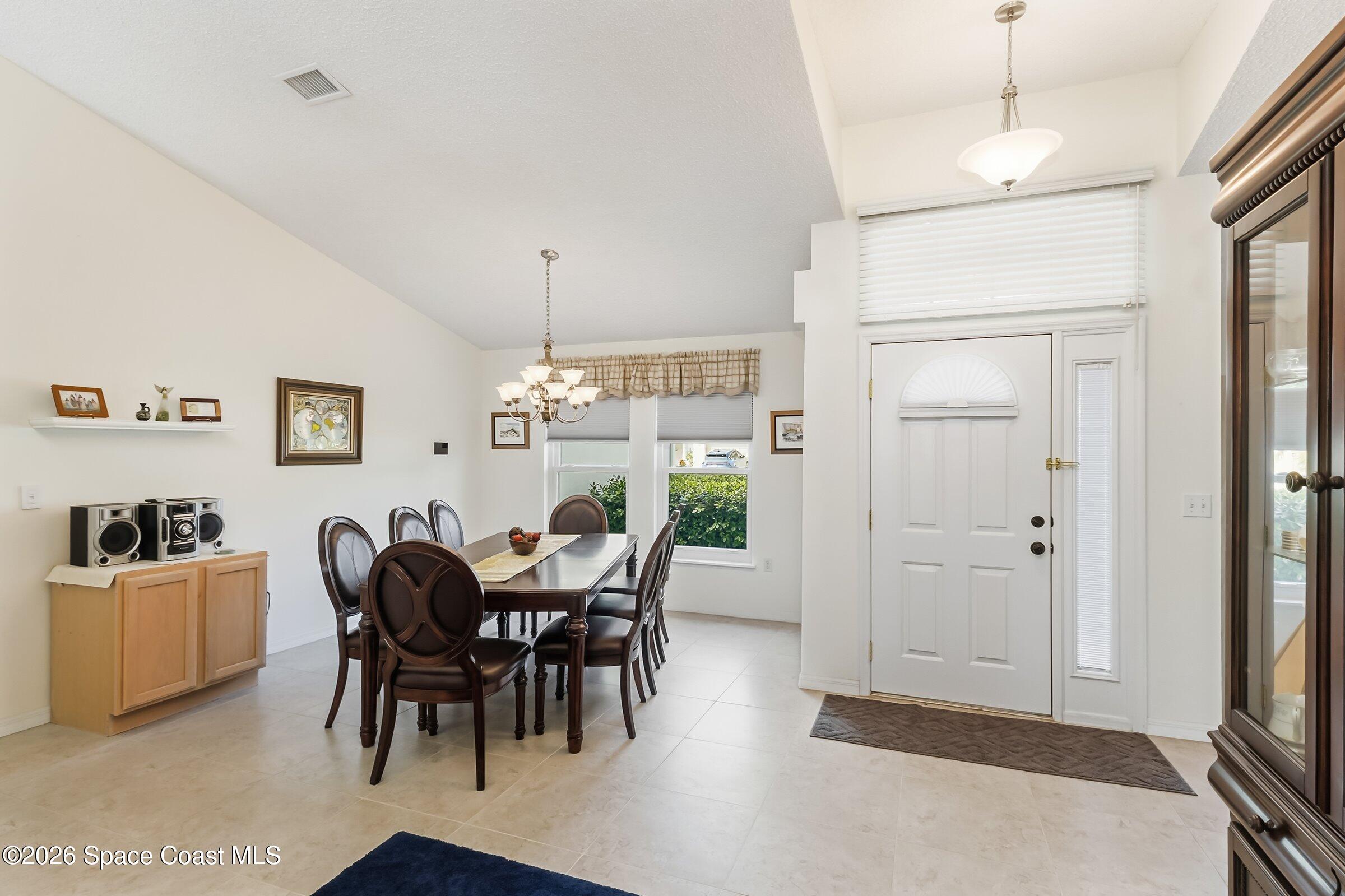 263 Mcclain Drive Melbourne, FL 32904 - Photo 19 of 56 a view of a dining room with furniture and chandelier
