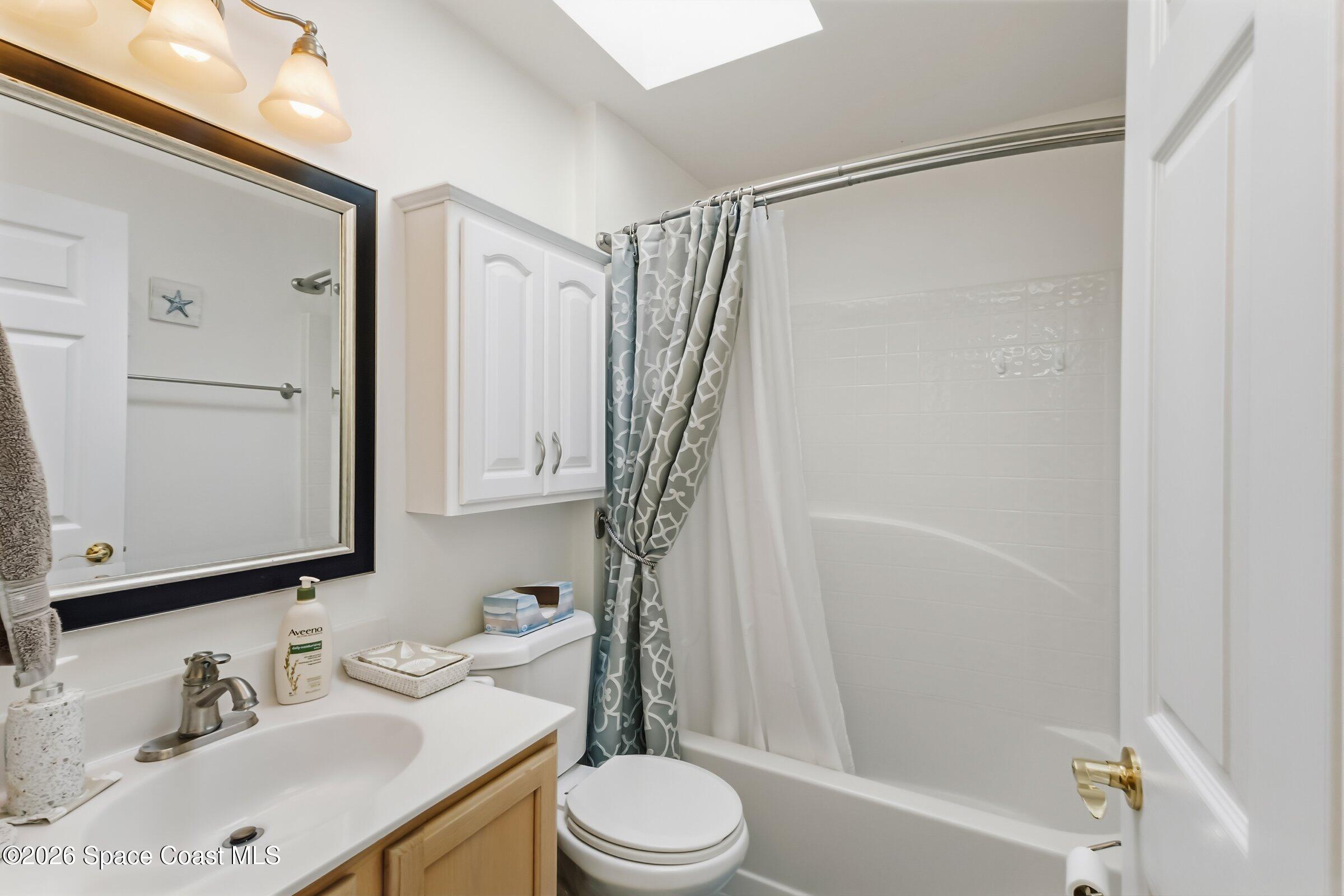 263 Mcclain Drive Melbourne, FL 32904 - Photo 30 of 56 a bathroom with a sink a toilet and shower