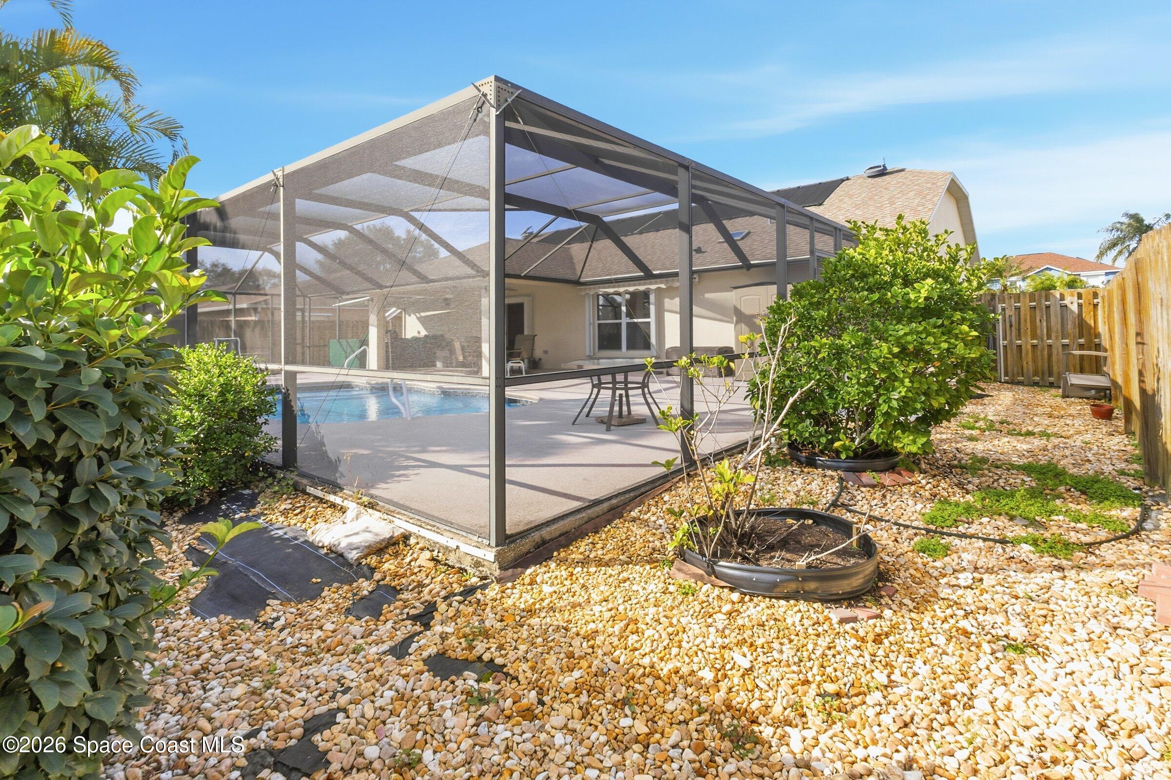 263 Mcclain Drive Melbourne, FL 32904 - Photo 40 of 56 a backyard of a house with table and chairs
