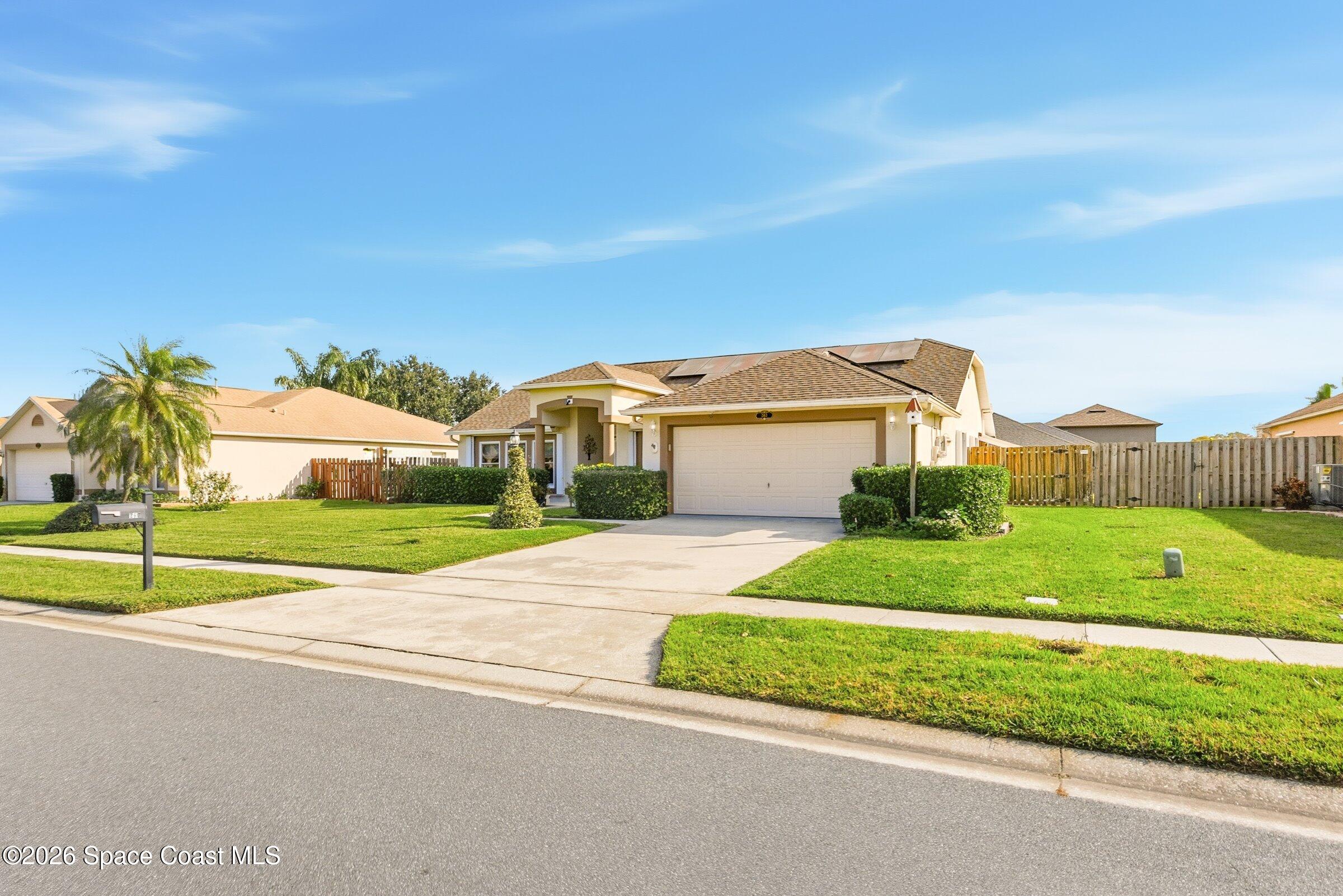 263 Mcclain Drive Melbourne, FL 32904 - Photo 4 of 56 a view of a house with a big yard and large trees