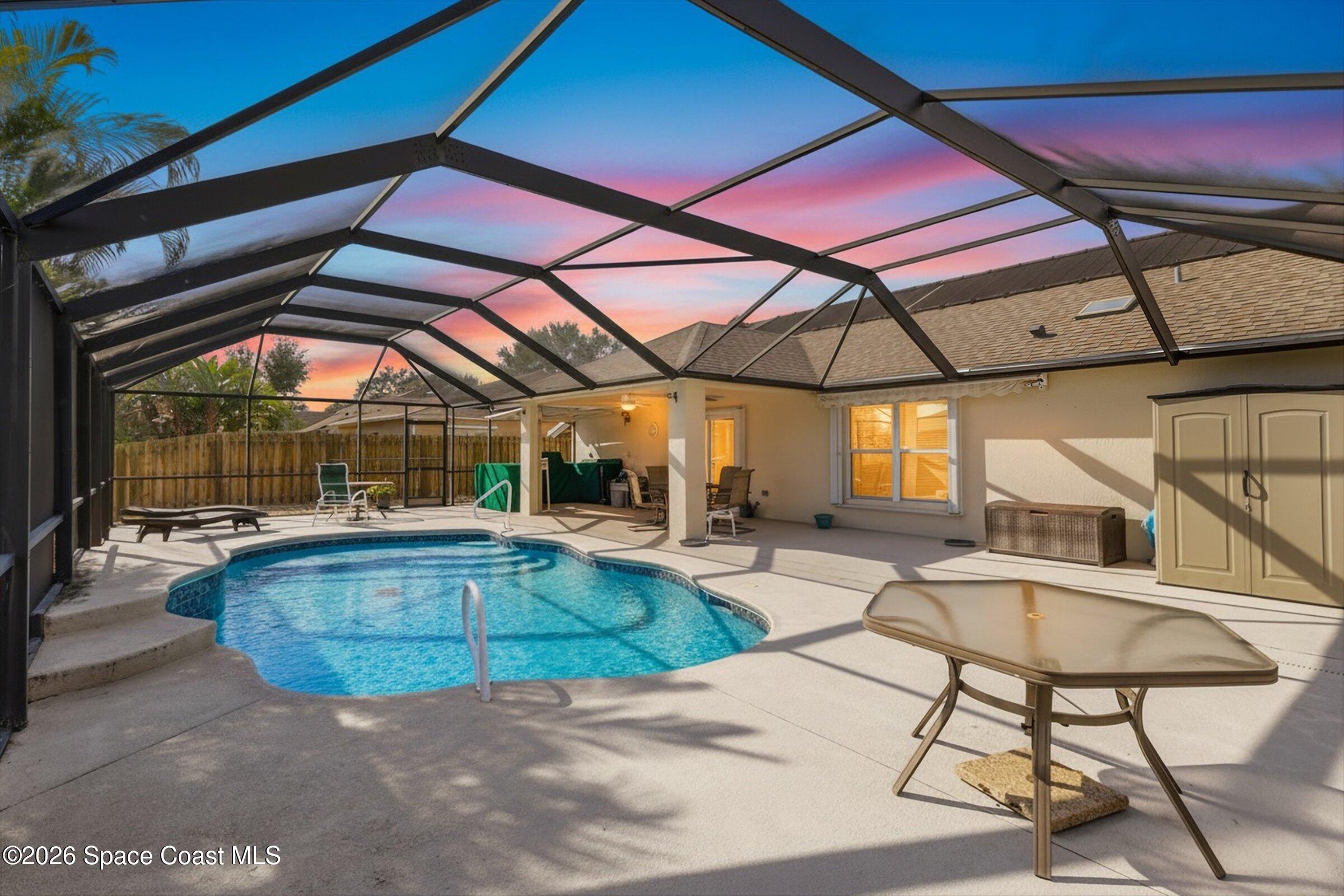 263 Mcclain Drive Melbourne, FL 32904 - Photo 7 of 56 a view of pool with a table and chairs under an umbrella