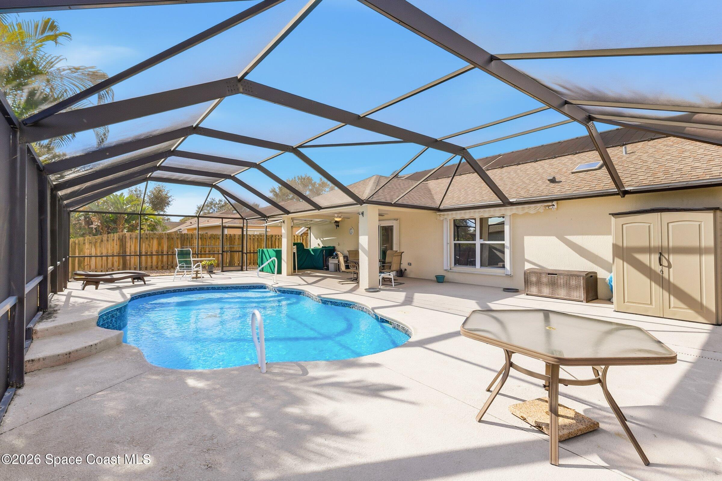 263 Mcclain Drive Melbourne, FL 32904 - Photo 8 of 56 a view of a swimming pool with a patio