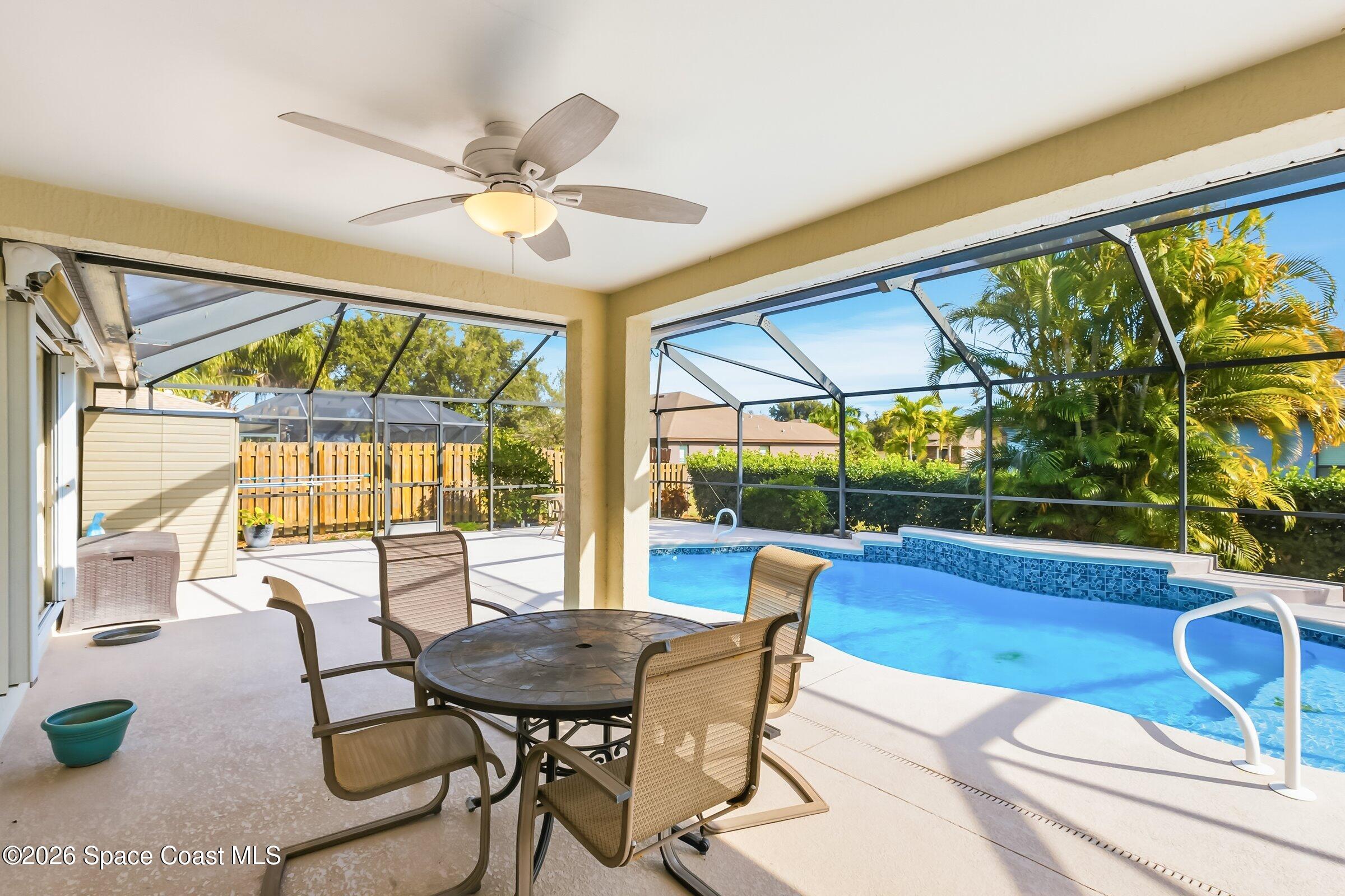 263 Mcclain Drive Melbourne, FL 32904 - Photo 9 of 56 a view of a dining room with furniture wooden floor and a chandelier