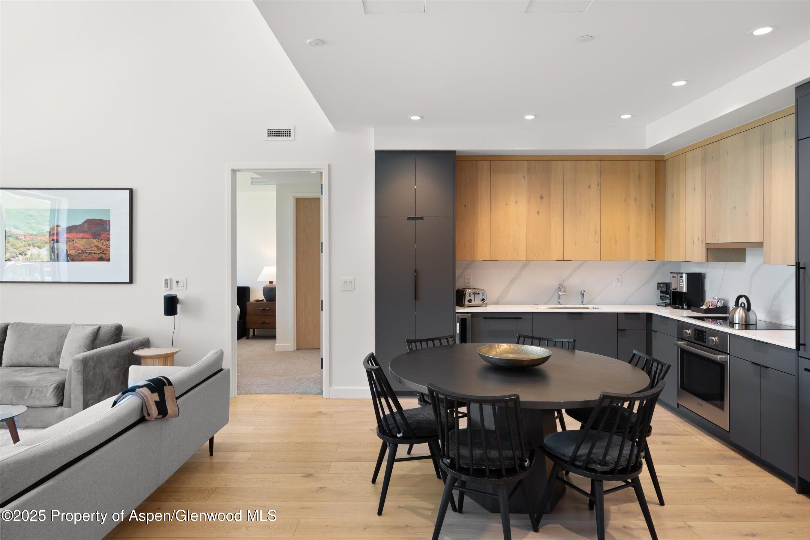 119 Wood Road, Unit 604 Snowmass Village, CO 81615 - Photo 14 of 48 a kitchen with a table and chairs in it