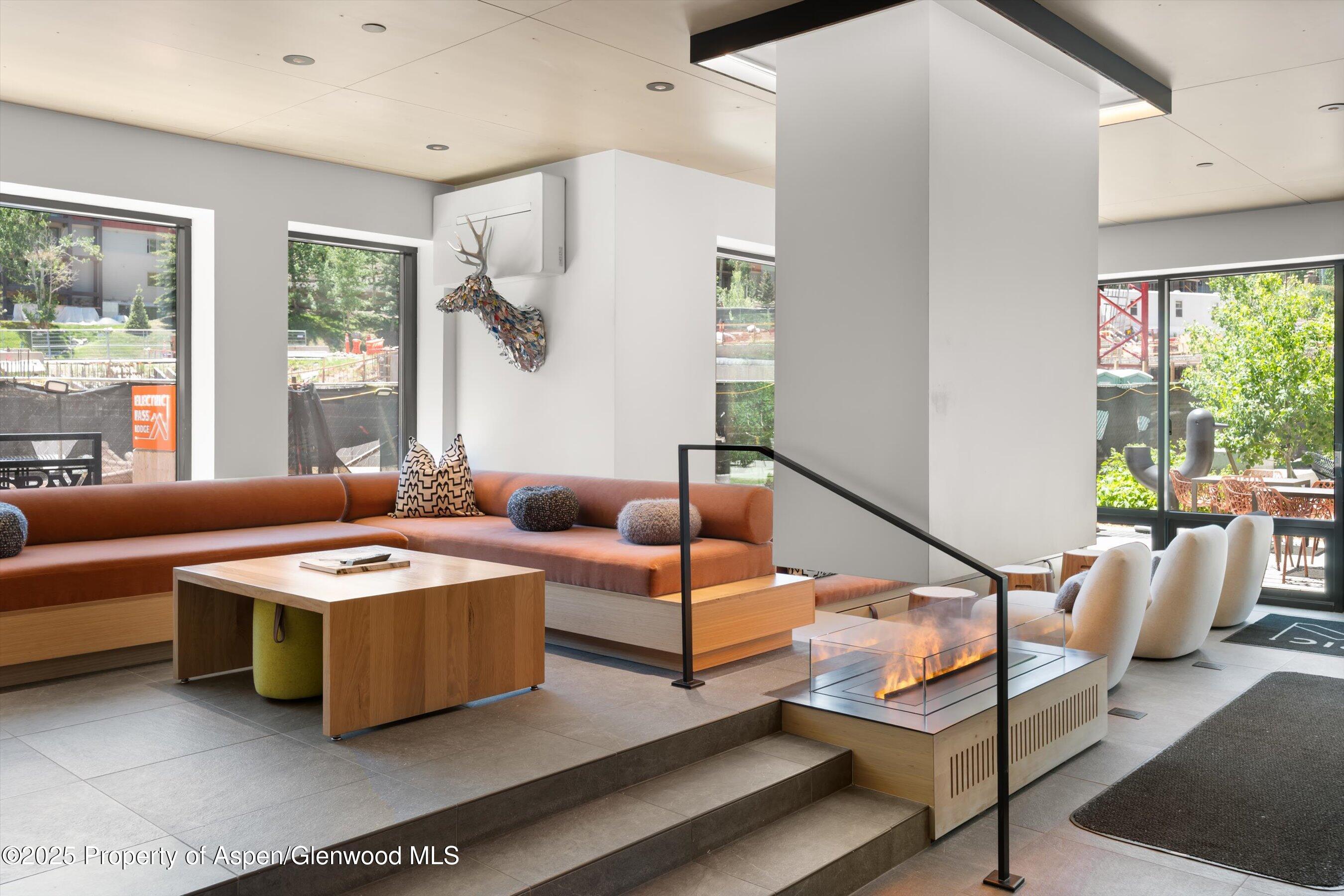 119 Wood Road, Unit 604 Snowmass Village, CO 81615 - Photo 32 of 48 a living room with furniture and a large window