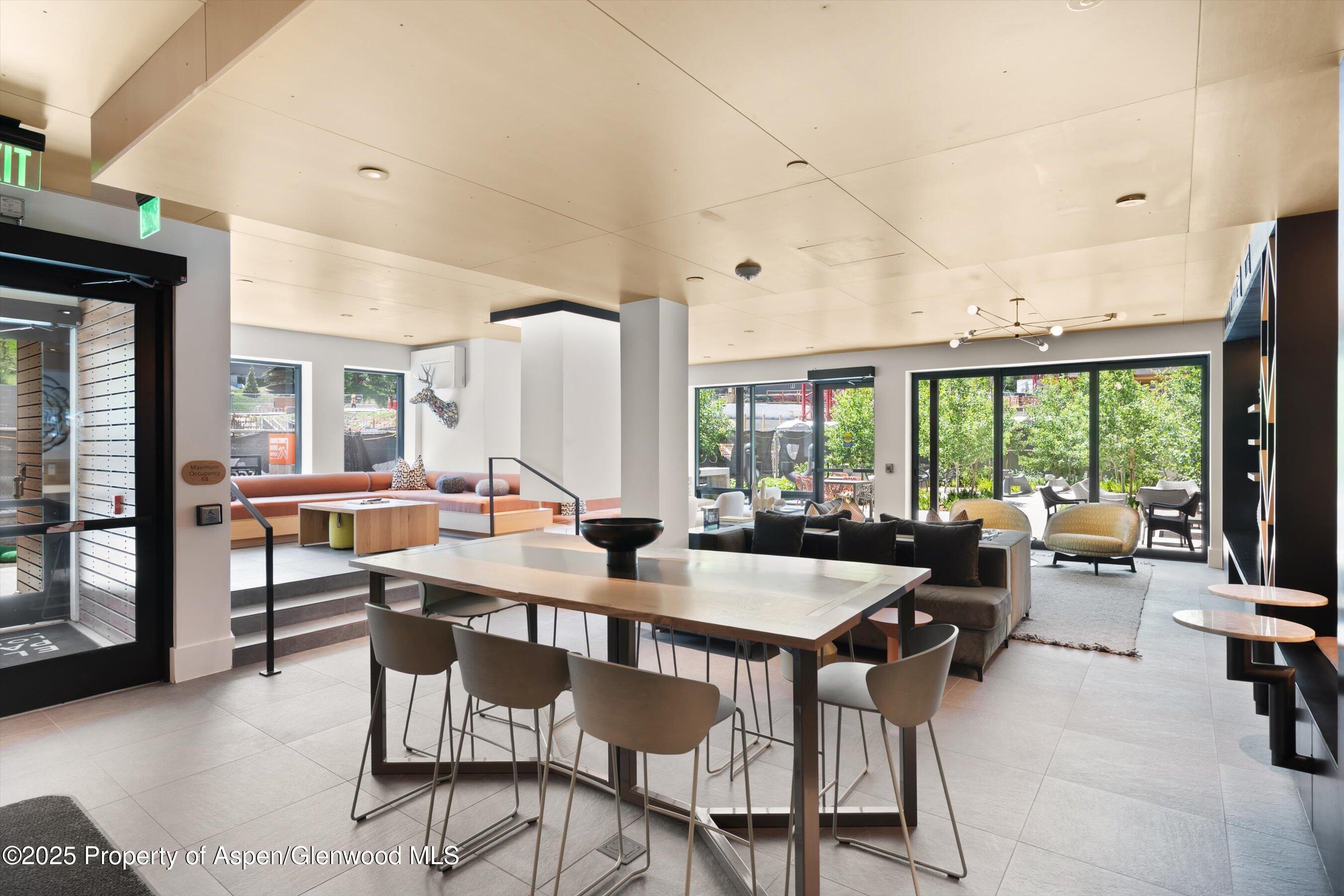 119 Wood Road, Unit 604 Snowmass Village, CO 81615 - Photo 33 of 48 a room with lots of furniture and a large window