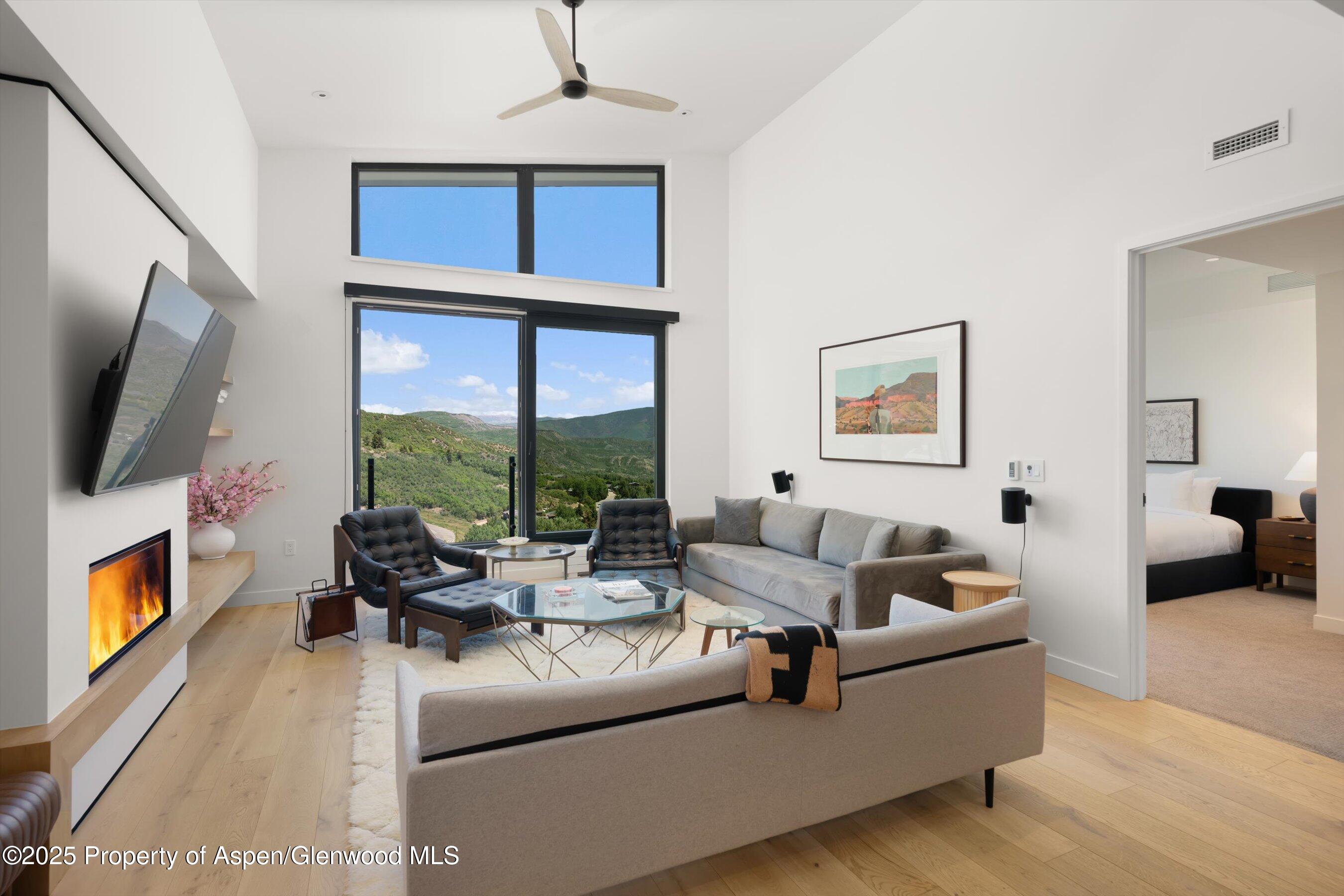 119 Wood Road, Unit 604 Snowmass Village, CO 81615 - Photo 6 of 48 a living room with furniture and a flat screen tv