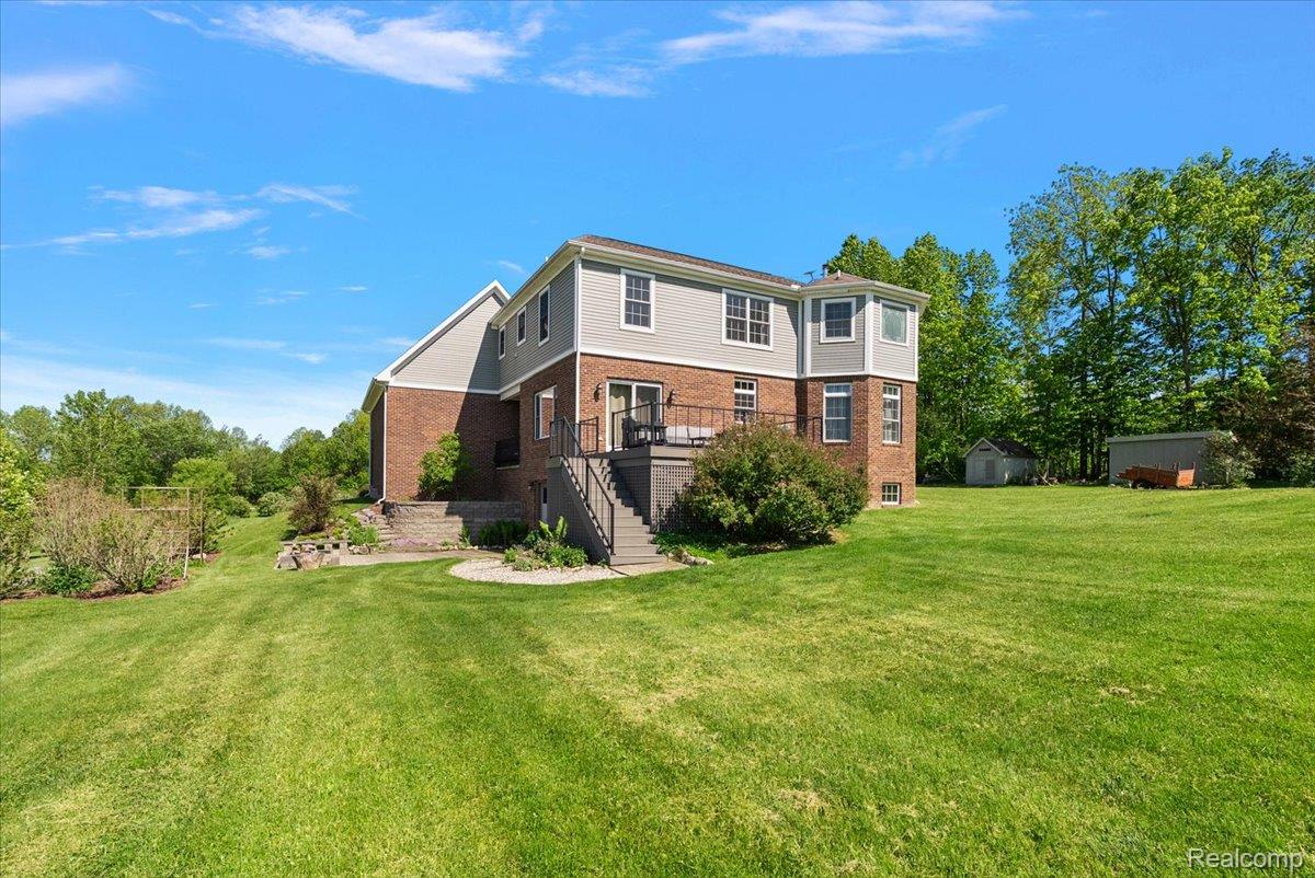 5035 Hidden Ridge Road Metamora, MI 48455 - Photo 59 of 65 Spacious rear exterior featuring a multi-level design with a brick and siding facade