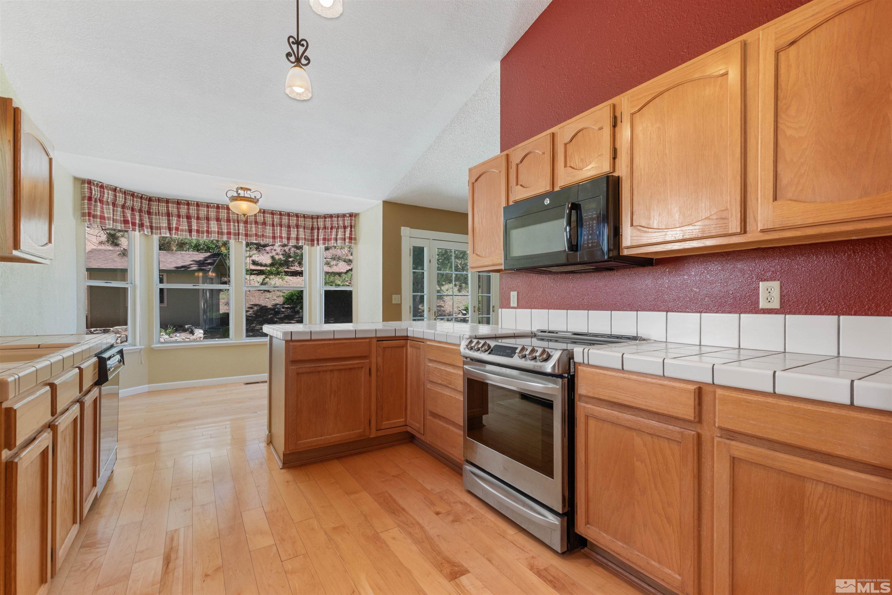 575 Cliff View Drive Reno, NV 89523 - Photo 17 of 33 a kitchen with stainless steel appliances granite countertop a stove and cabinets