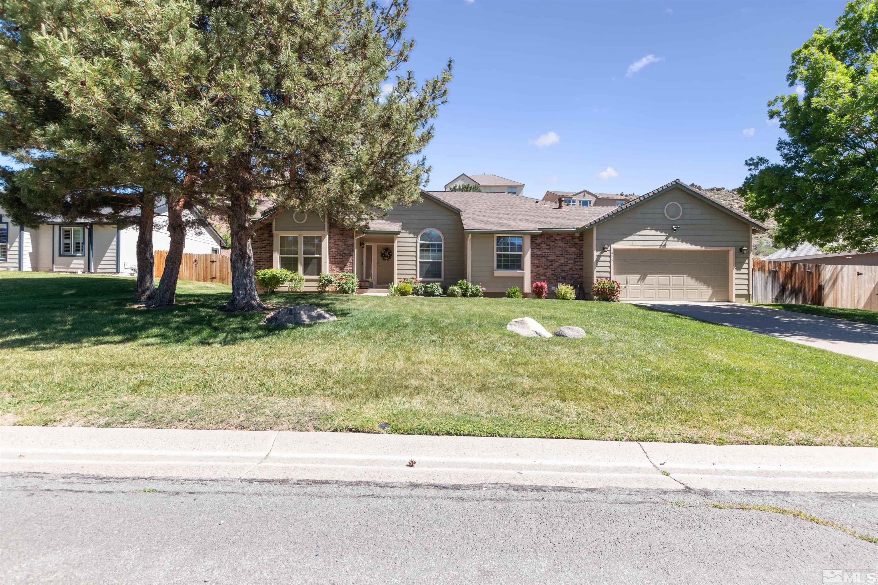 575 Cliff View Drive Reno, NV 89523 - Photo 2 of 33 a house with a yard and a large tree