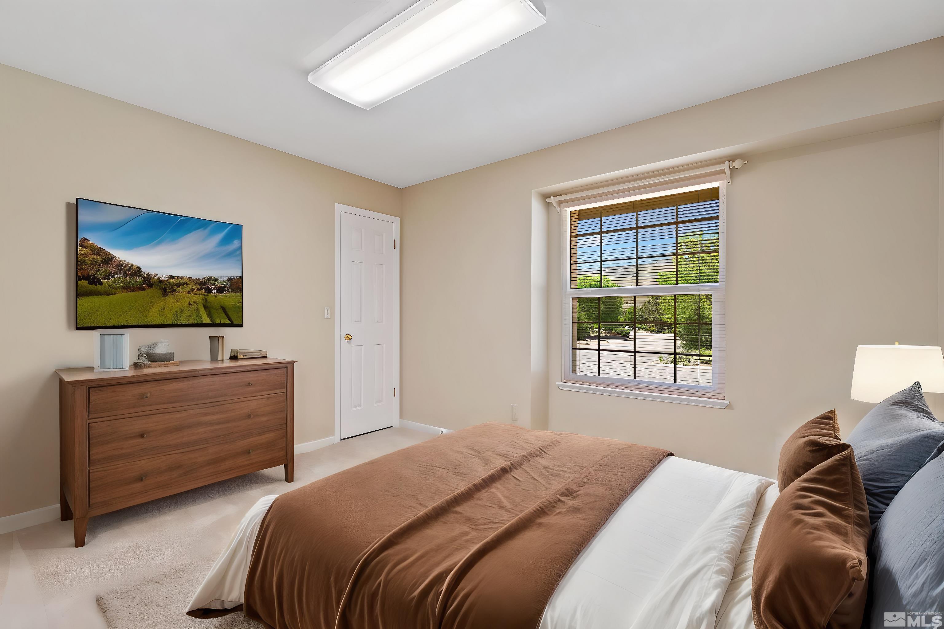 575 Cliff View Drive Reno, NV 89523 - Photo 22 of 33 a bedroom with a bed and a flat screen tv