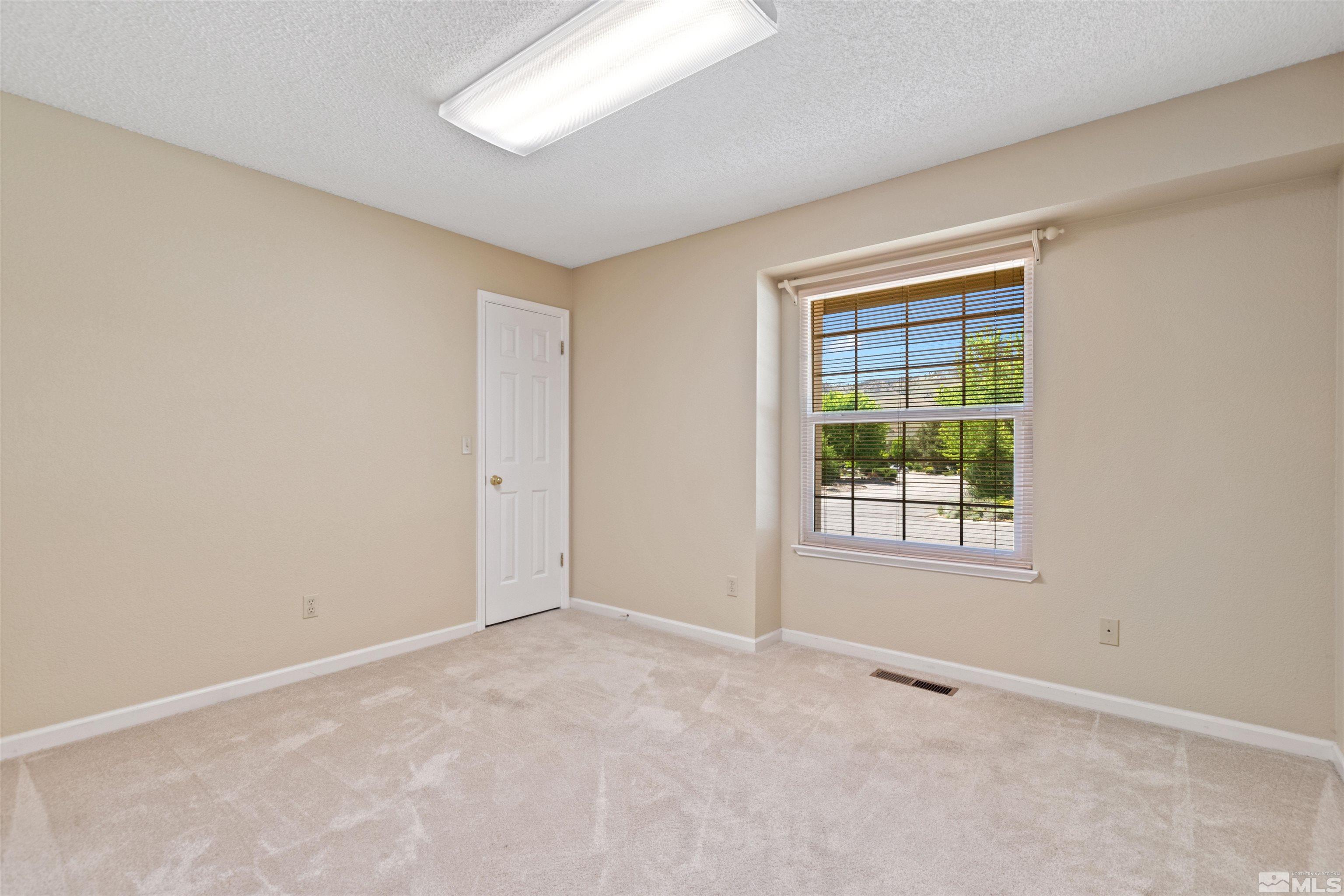 575 Cliff View Drive Reno, NV 89523 - Photo 23 of 33 an empty room with windows