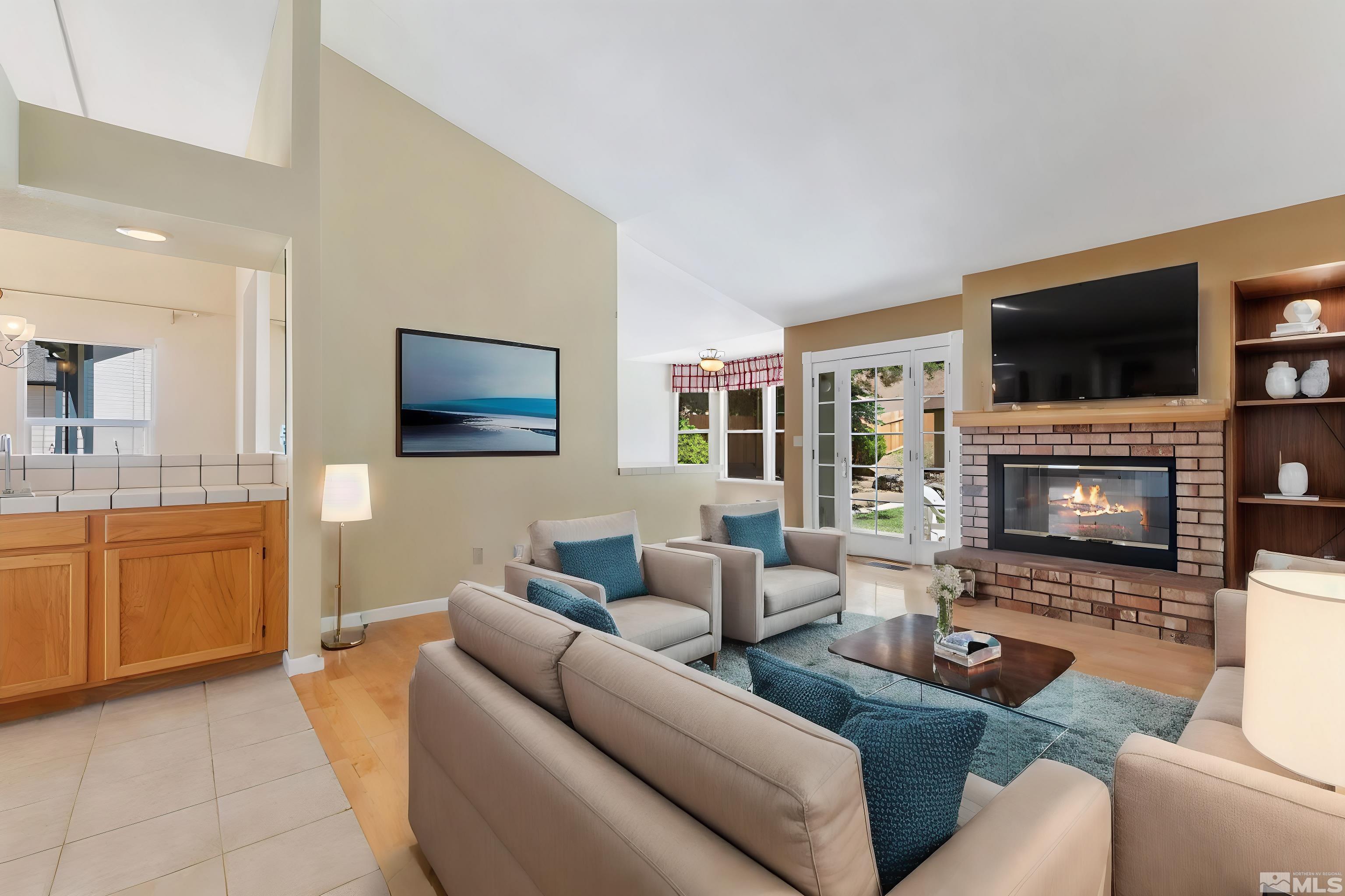575 Cliff View Drive Reno, NV 89523 - Photo 7 of 33 a living room with furniture a flat screen tv and a fireplace