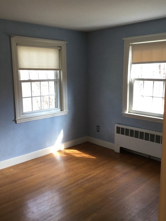 150 Barton Road Wellesley, MA 02481 - Photo 13 of 20 an empty room with wooden floor and windows