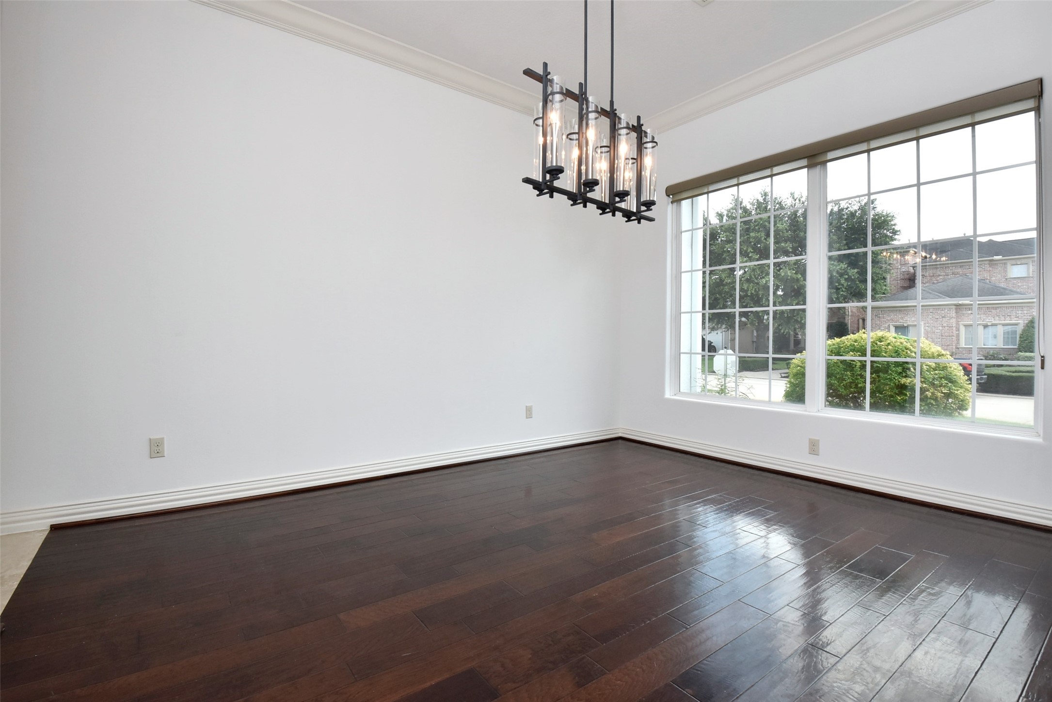 2014 Split Branch Court Houston, TX 77077 - Photo 5 of 47 an empty room with wooden floor chandelier and windows