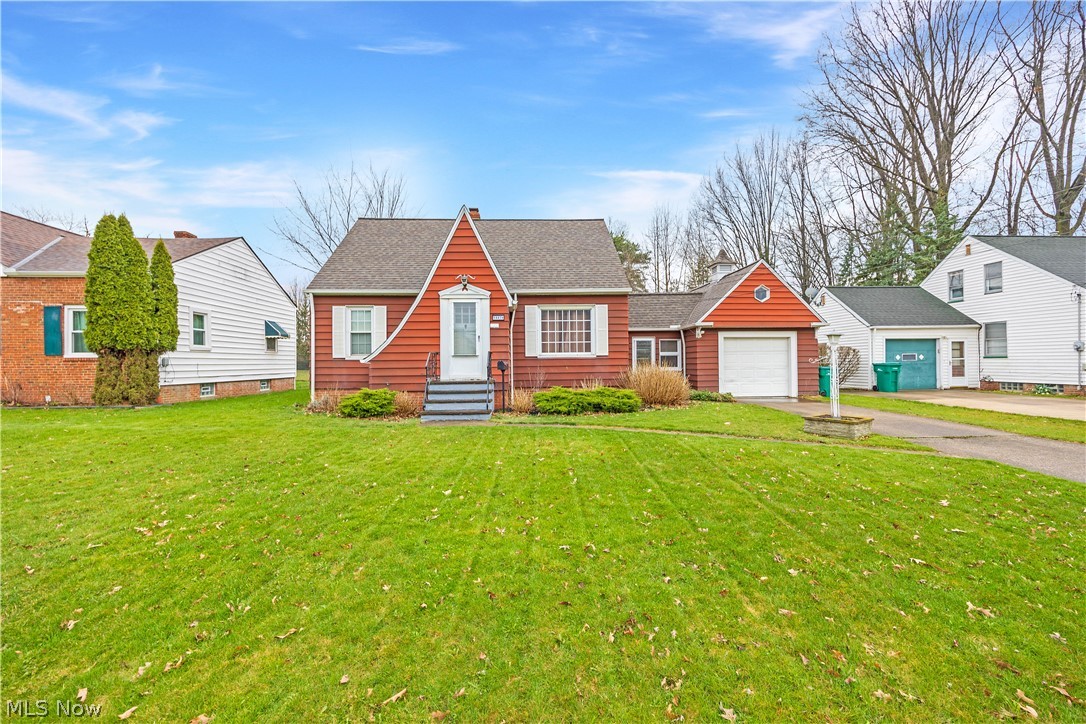 14474 Pease Road Maple Heights, OH 44137 - Photo 1 of 50 View of front of property featuring a front yard and a garage