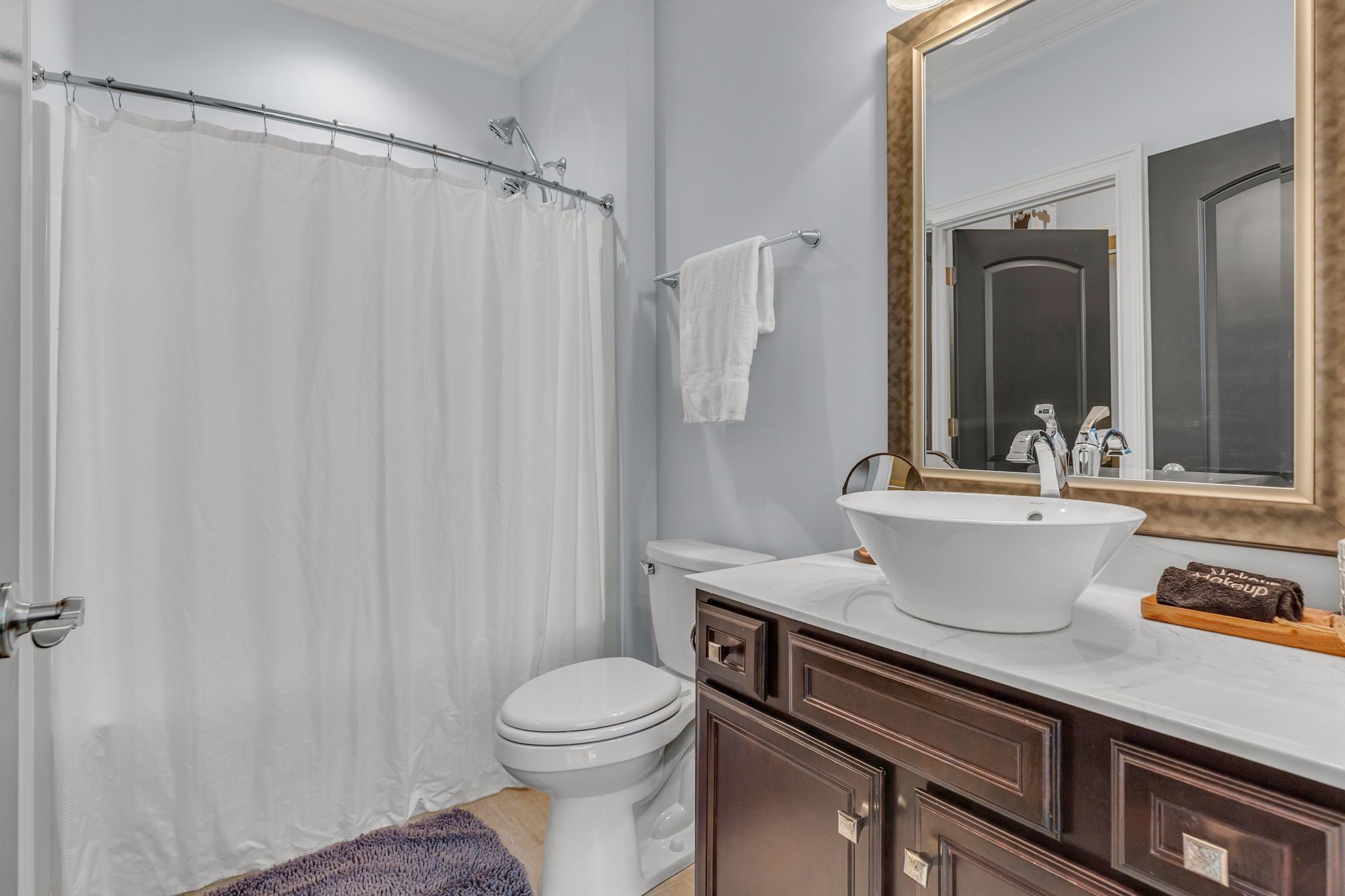 7167 Williams Road Christiana, TN 37037 - Photo 44 of 53 a bathroom with a sink a toilet and shower curtain