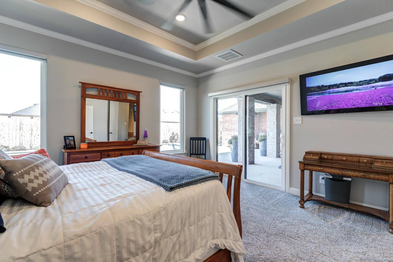 4908 109th Place Lubbock, TX 79424 - Photo 22 of 44 a bedroom with a bed and a chandelier