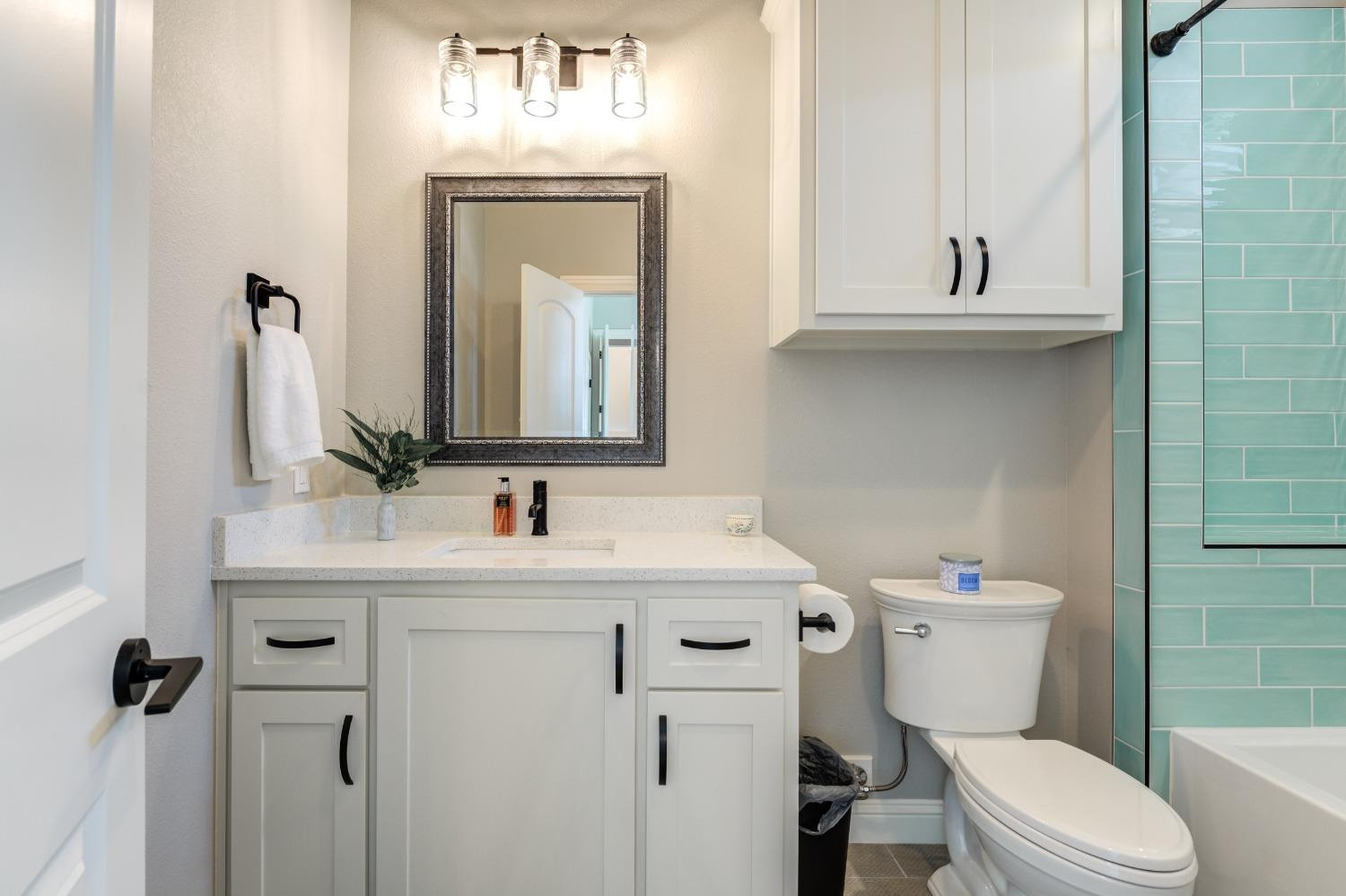 4908 109th Place Lubbock, TX 79424 - Photo 32 of 44 a bathroom with a toilet sink and mirror