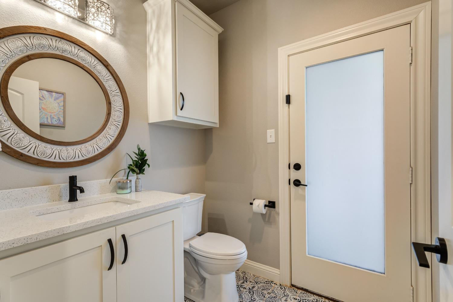 4908 109th Place Lubbock, TX 79424 - Photo 36 of 44 a bathroom with a sink a toilet and a mirror