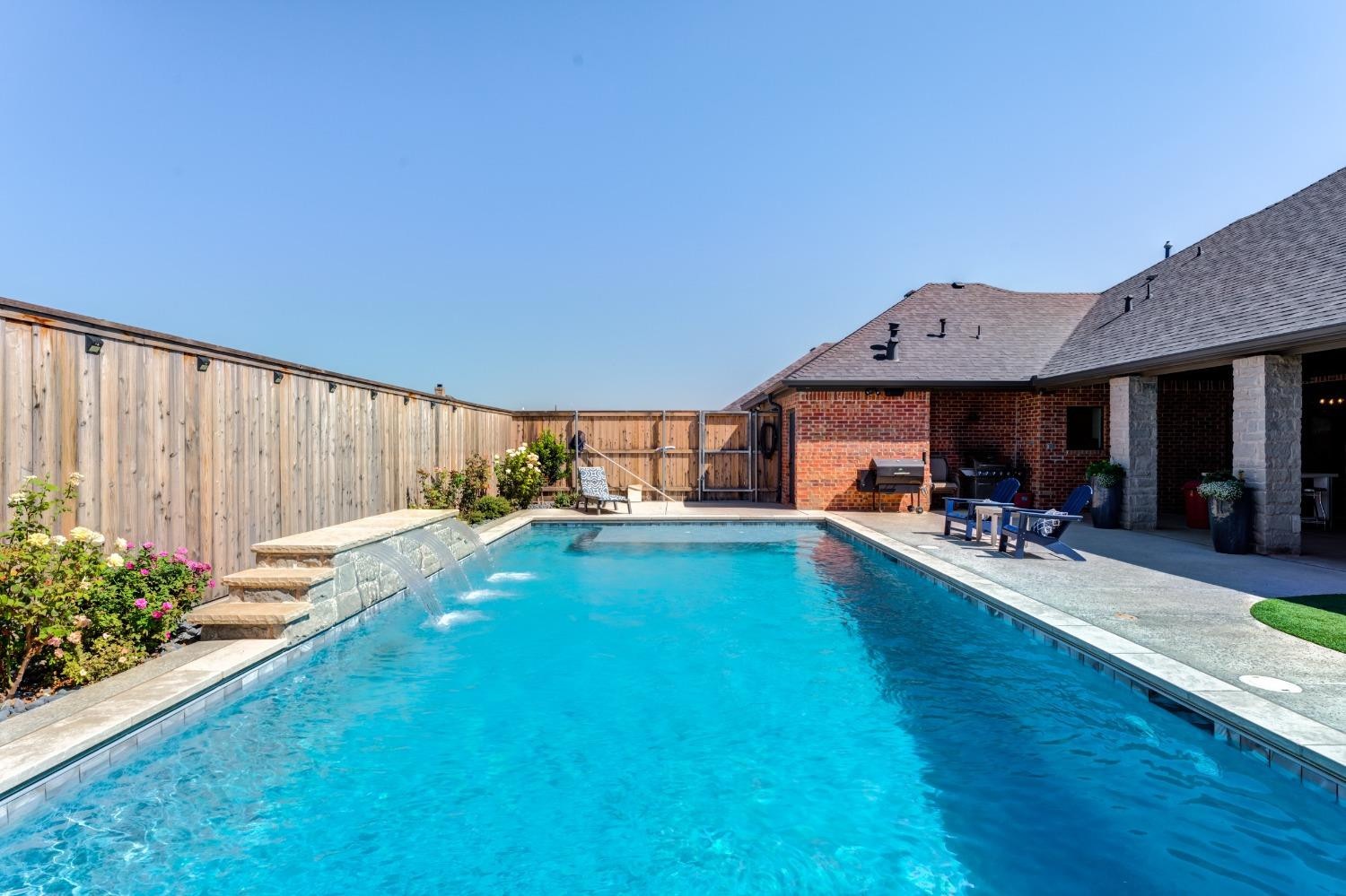 4908 109th Place Lubbock, TX 79424 - Photo 38 of 44 a view of swimming pool with seating space and garden
