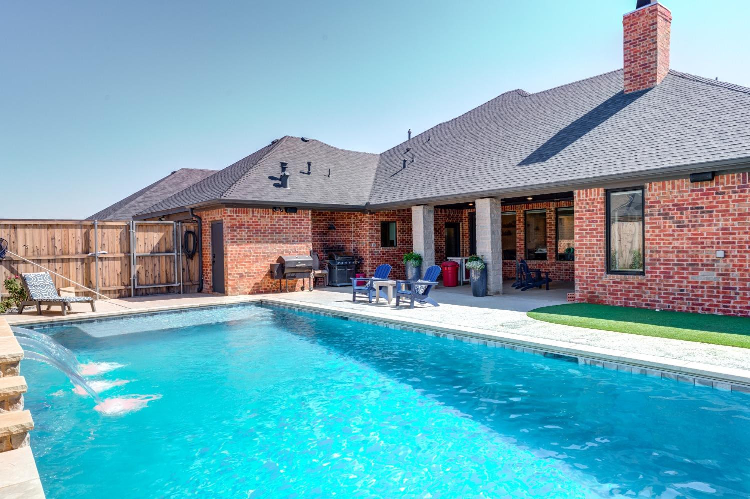 4908 109th Place Lubbock, TX 79424 - Photo 39 of 44 a front view of a house with swimming pool having outdoor seating
