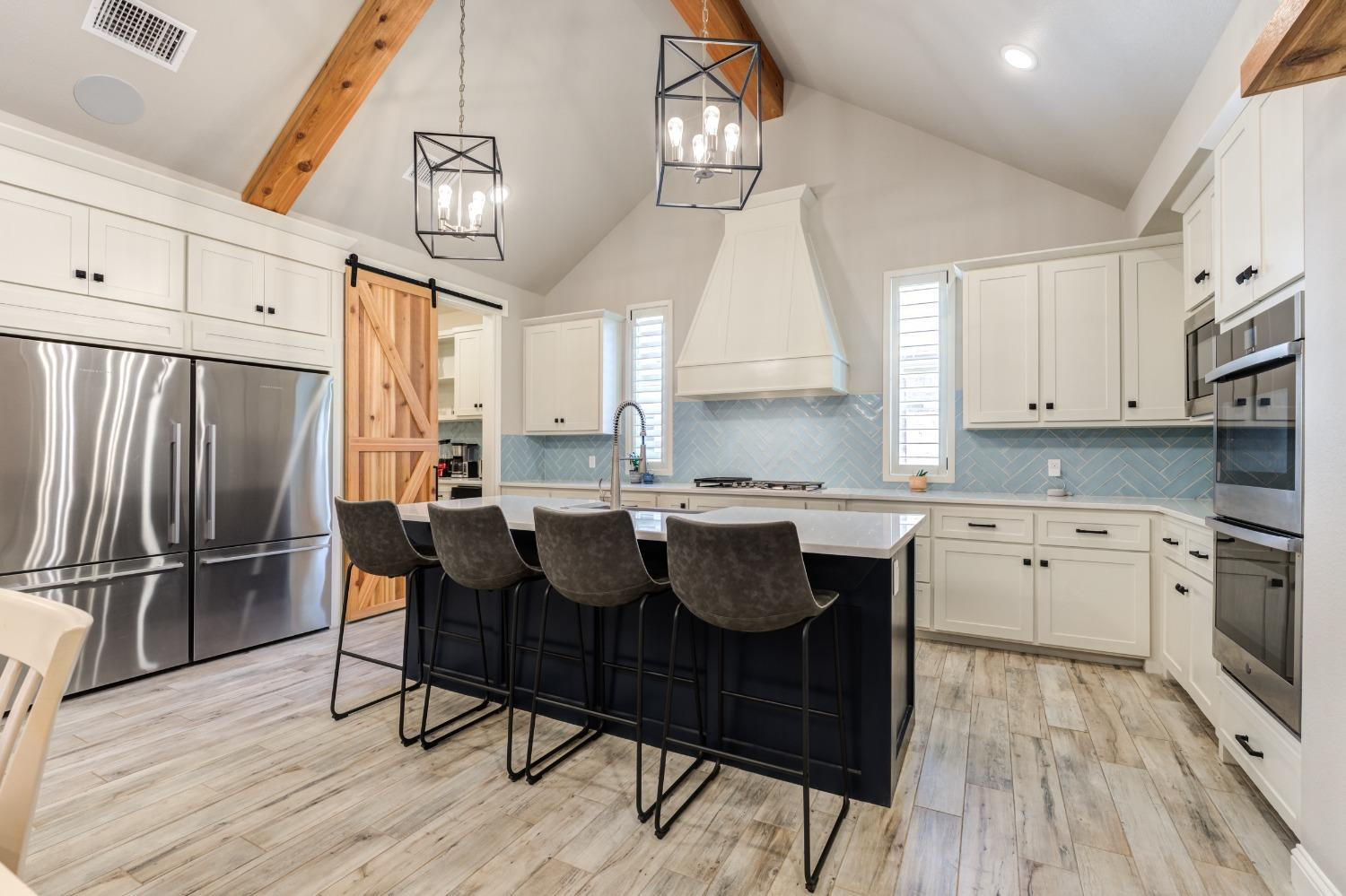 4908 109th Place Lubbock, TX 79424 - Photo 6 of 44 a kitchen with stainless steel appliances granite countertop a sink a stove a refrigerator cabinets and a dining table