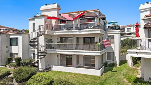 a front view of a residential apartment building with a yard