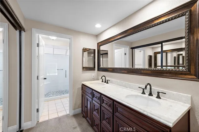 a bathroom with a sink double vanity and a mirror