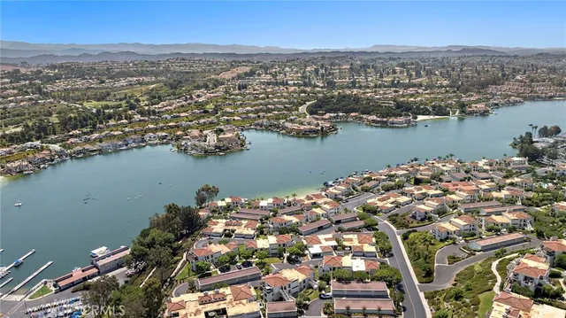 an aerial view of a city with lots of residential buildings lake and ocean view