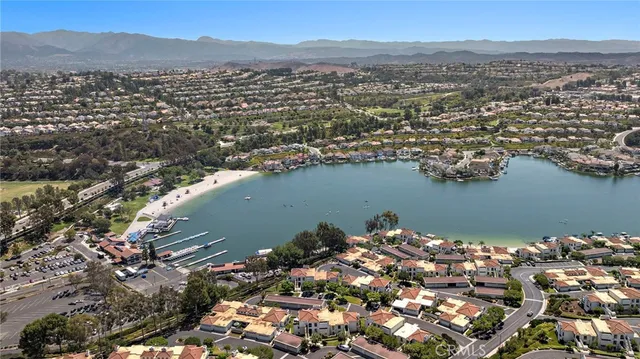 an aerial view of a houses with a lake