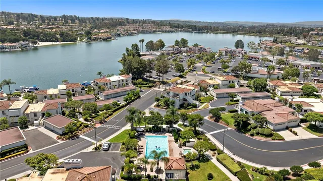 an aerial view of lake and residential houses with outdoor space