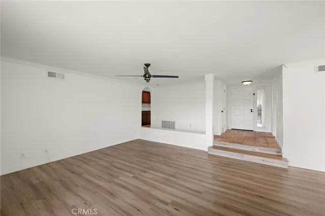 a view of empty room with wooden floor