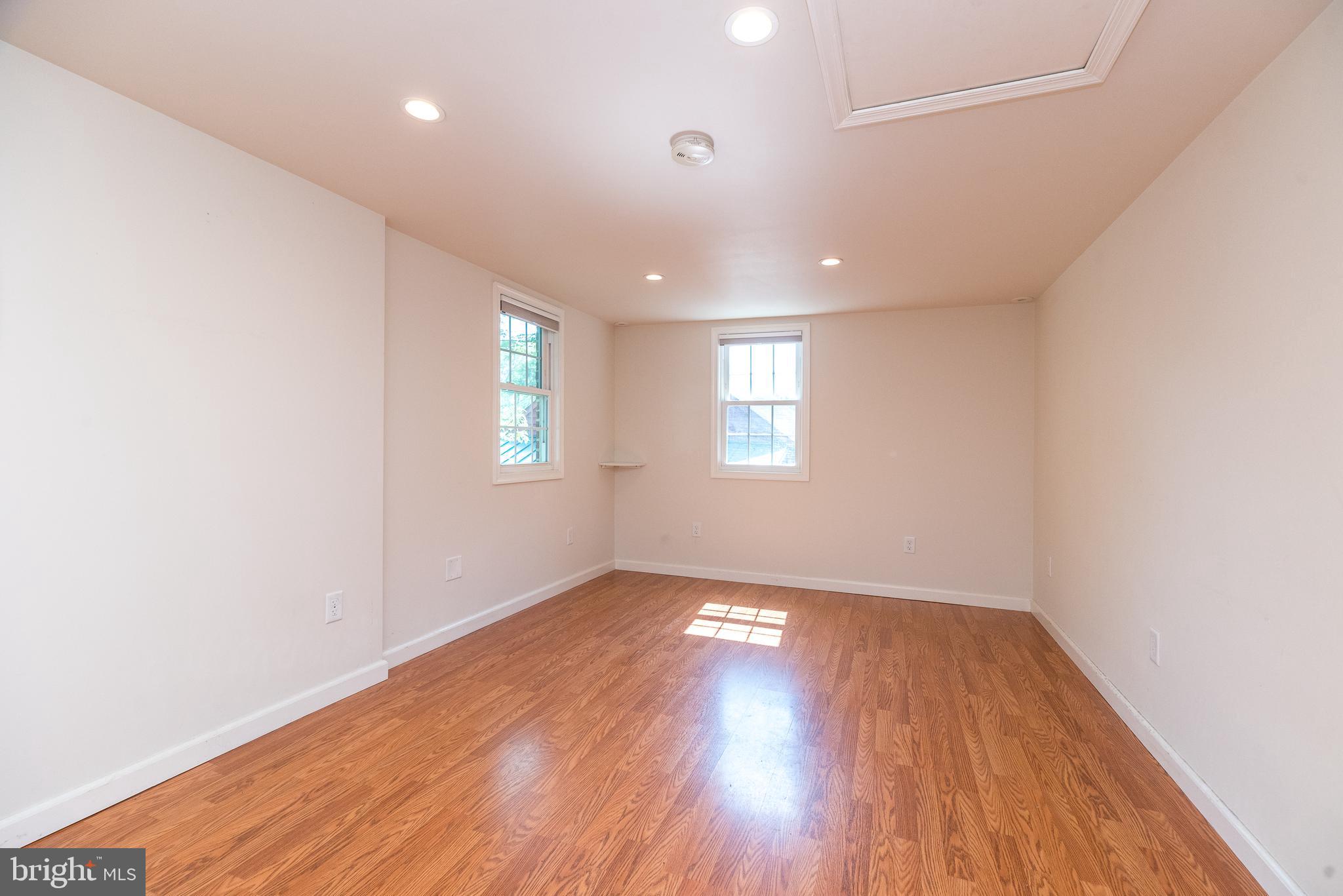 2478 River Road, Unit CARRIAGE New Hope, PA 18938 - Photo 11 of 23 an empty room with wooden floor and windows