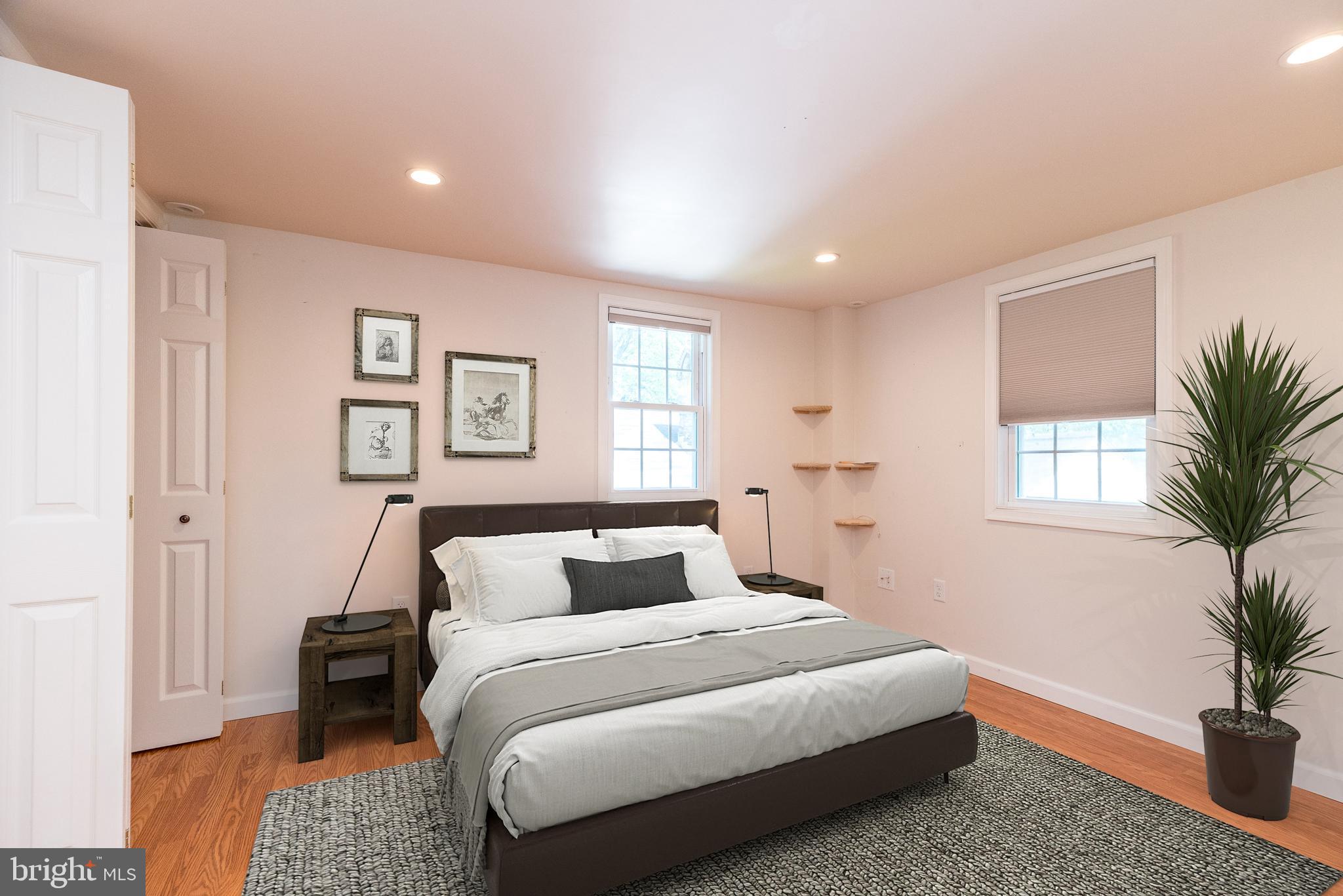 2478 River Road, Unit CARRIAGE New Hope, PA 18938 - Photo 15 of 23 a bedroom with a large bed and a potted plant