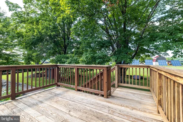 a balcony with wooden floor and fence
