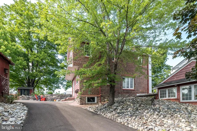 a front view of a house with a yard and trees