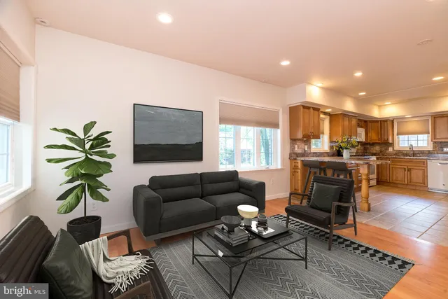 a living room with furniture and kitchen view