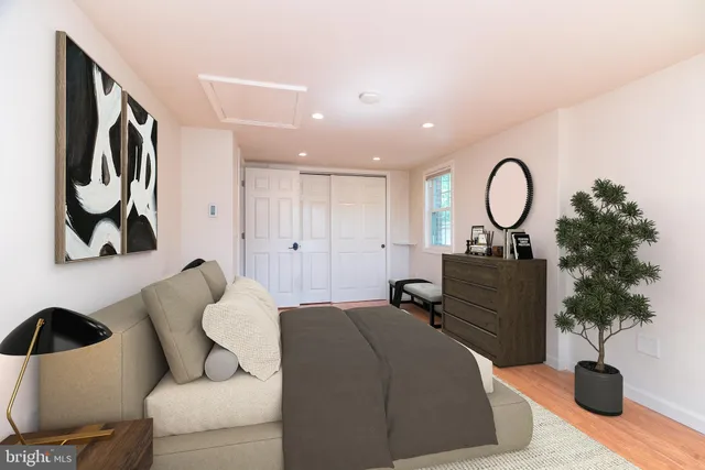 a bedroom with a bed and a potted plant