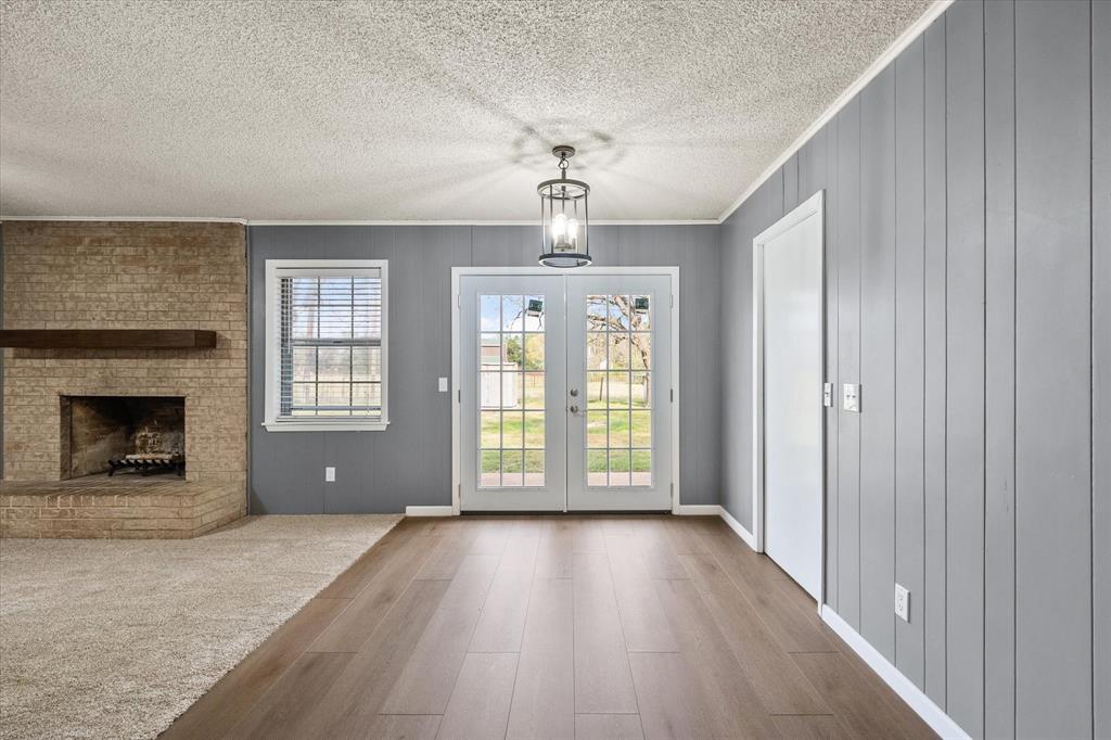 536 Robindale Lane Fairfield, TX 75840 - Photo 19 of 38 an empty room with wooden floor fireplace and windows