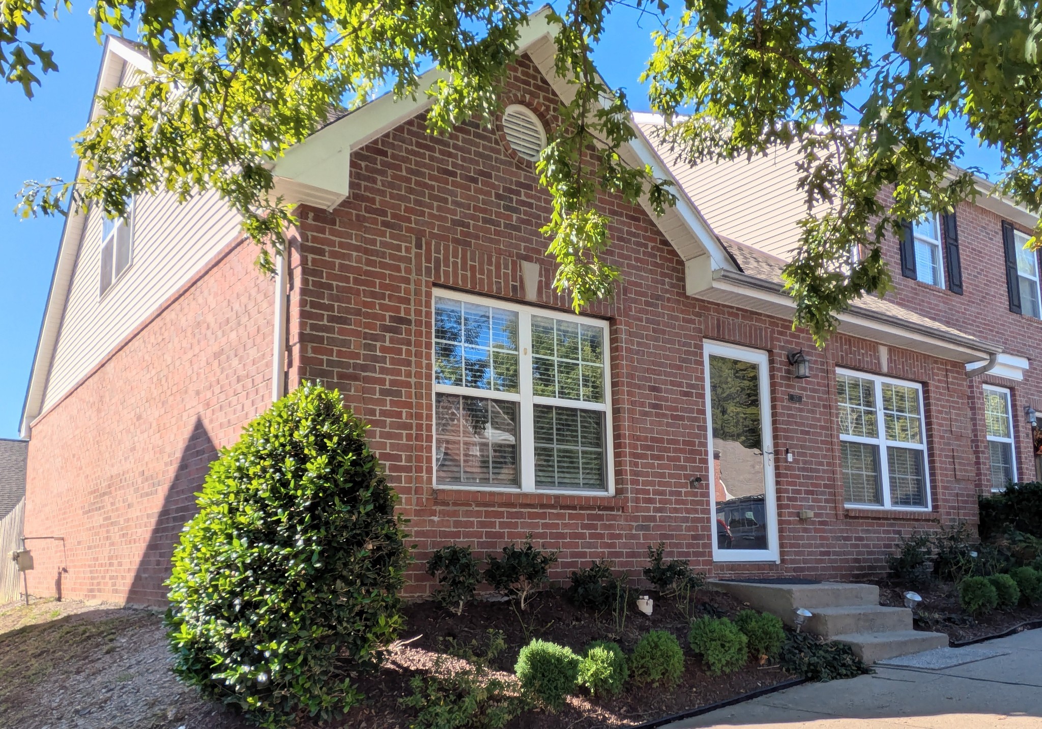 1101 Downs Boulevard, Unit 267 Franklin, TN 37064 - Photo 1 of 2 a front view of a house with garden