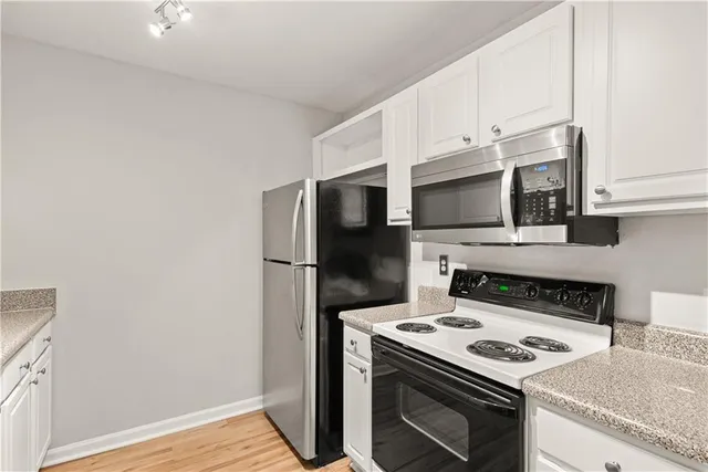 a kitchen with a stove and a microwave