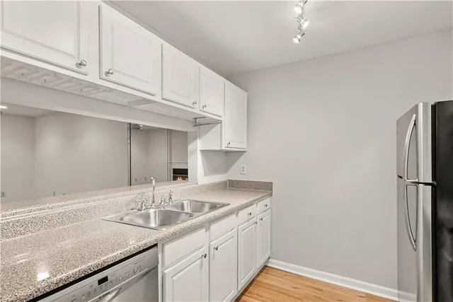 a kitchen with a sink cabinets and a refrigerator