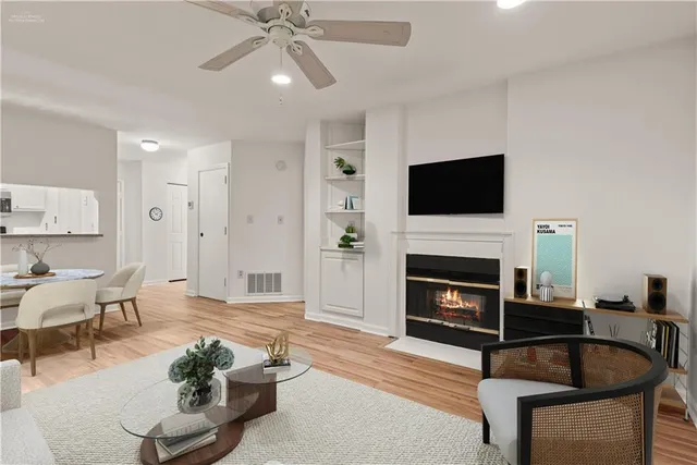 a living room with furniture a fireplace and a flat screen tv