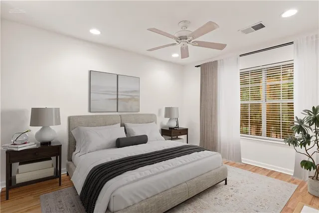 a bedroom with a large bed and a window